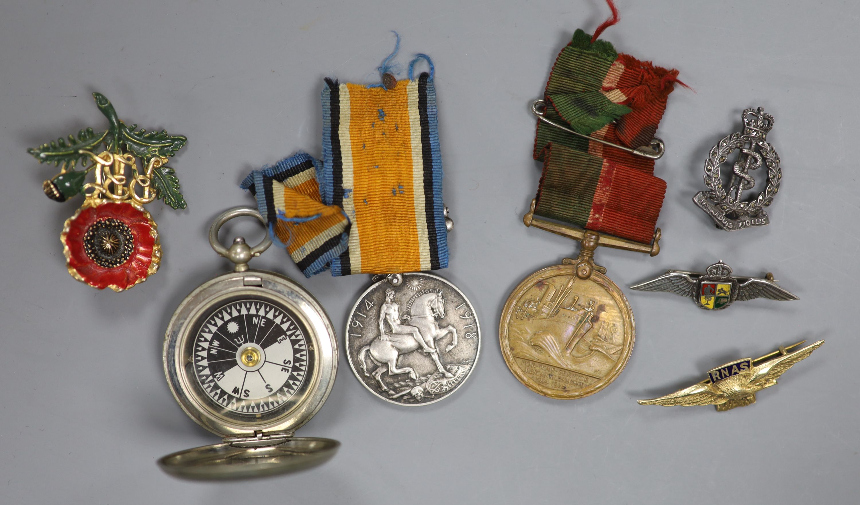 A WWI compass and two medals, together with lapel badges, etc.